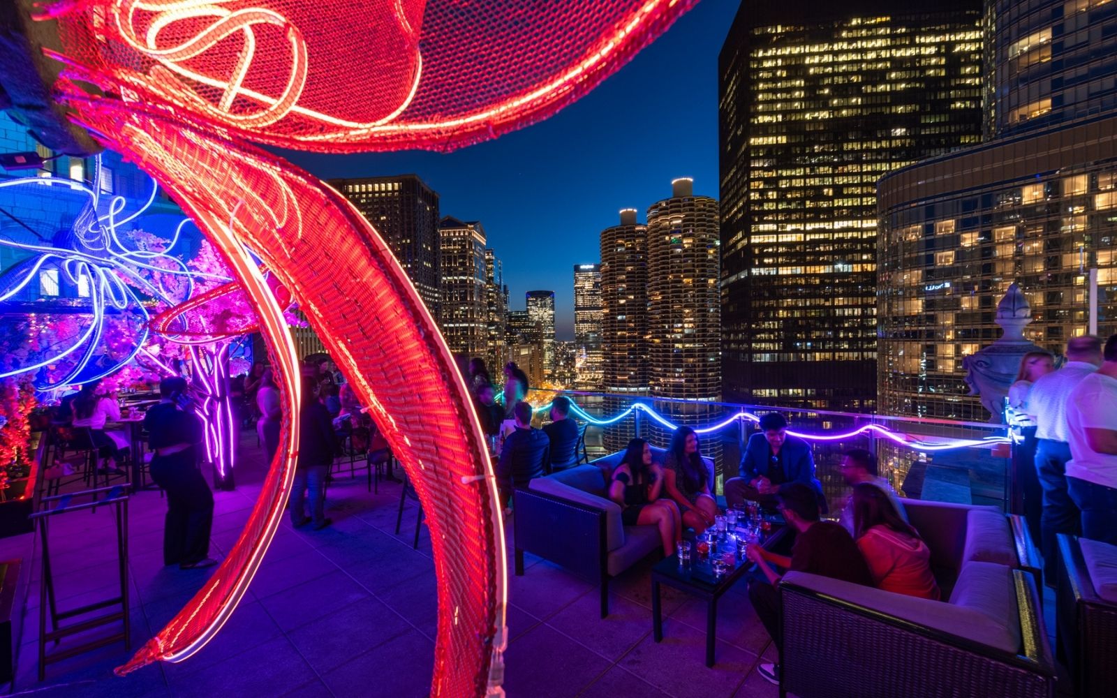 Vibrant cityscape at night with Helium Mobile hotspots illuminating rooftops and public spaces, showcasing decentralized wireless coverage in 2025